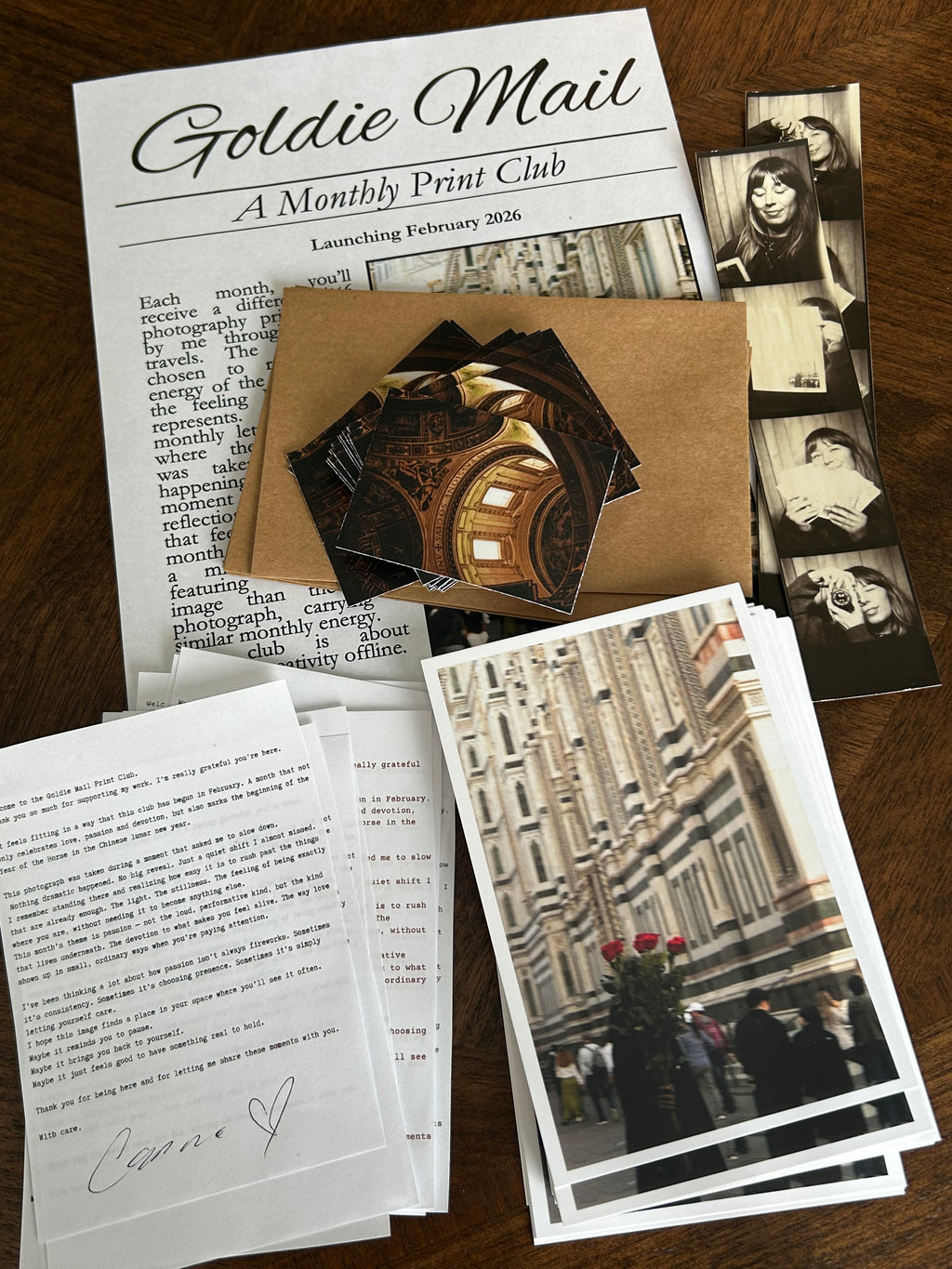 Collection of vintage photographs and printed materials on a wooden surface